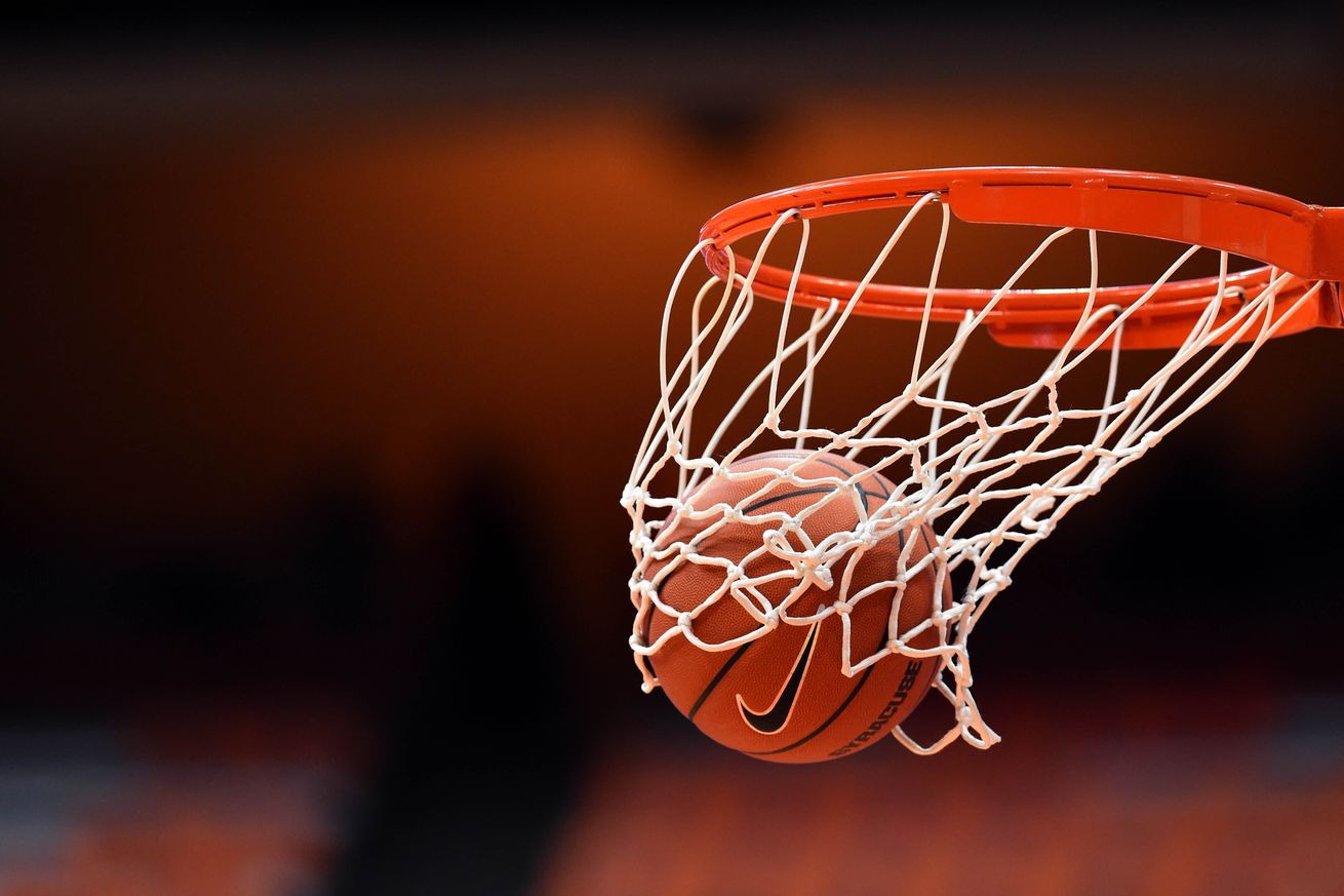 Basketball dropping through the net