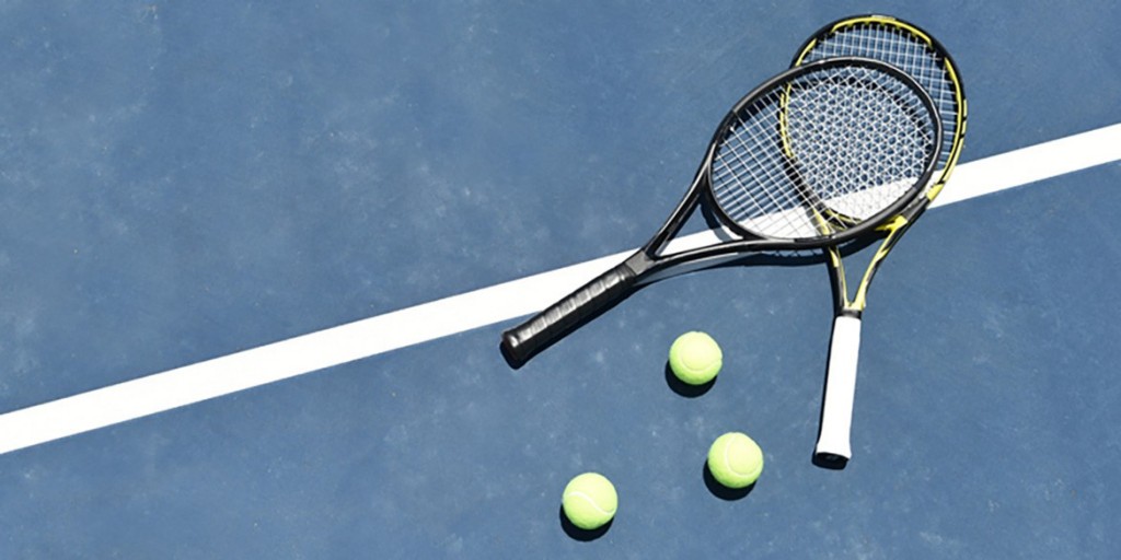 Tennis racquets and balls on the court line